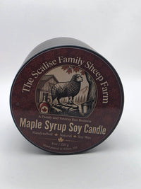 Close-up of the Maple Syrup Soy Candle label with sheep, barn and maple tap bucket