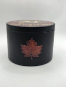 Side view of the black Maple Syrup Soy Candle tin with maple leaf