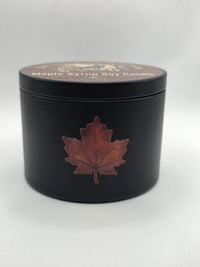 Side view of the black Maple Syrup Soy Candle tin with maple leaf
